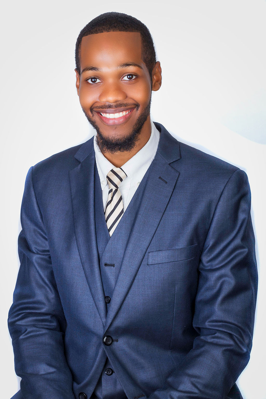 Professional studio headshot of M. H. Palmer, CEO and senior notary apostille agent smiling warmly, wearing a tailored navy blue three-piece suit with a striped tie against a clean white background, representing Sealing Time Mobile Notaries / Notary Apostille Agents for notary public new york city services.